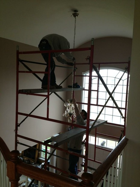 Our careful contractors on the scaffolding, installing our chandelier